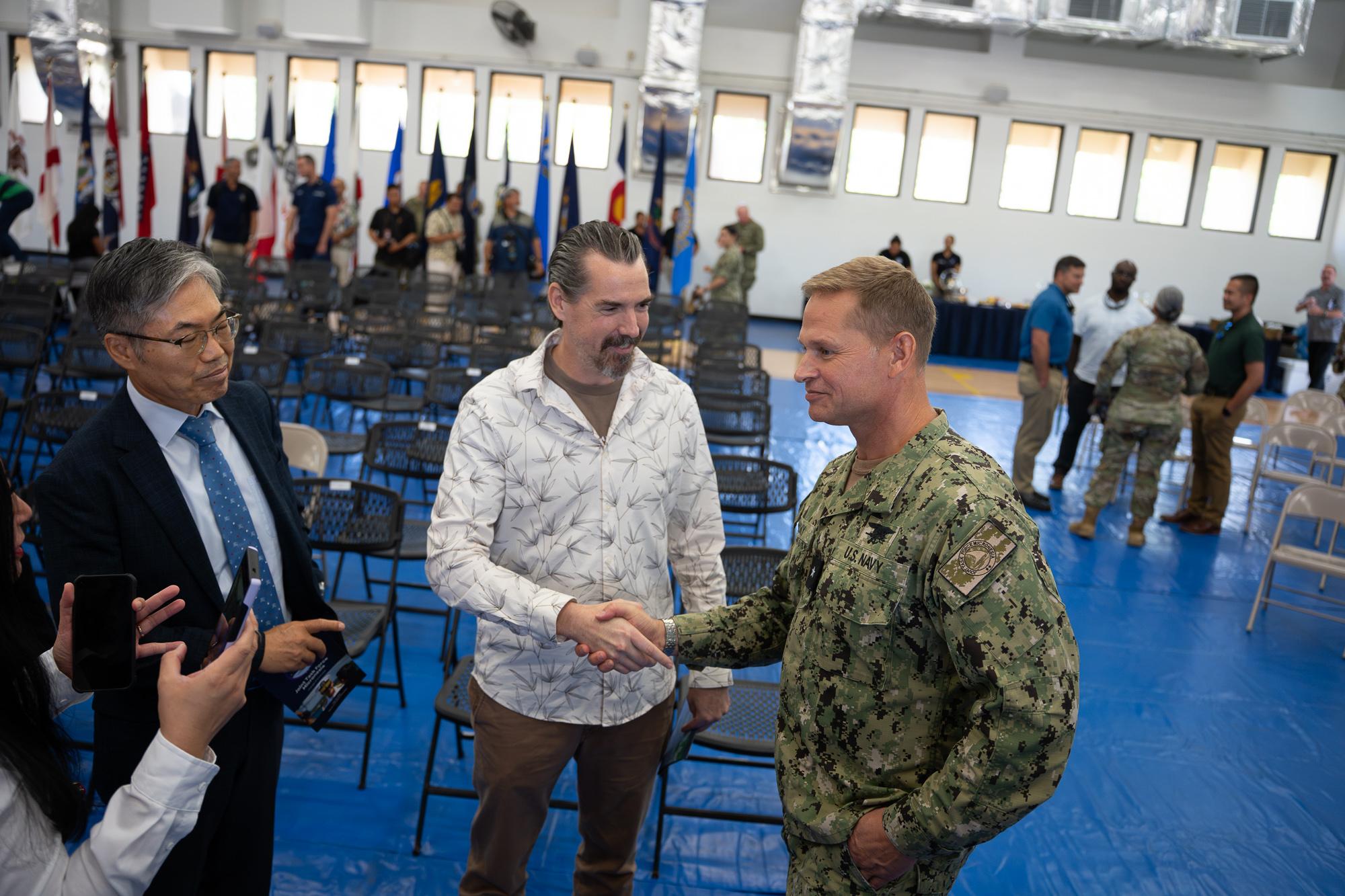 Jack Scogin, general manager of APL Guam, shakes hands with Lasky after the change of command ceremony. Photo by Skyler Obispo 