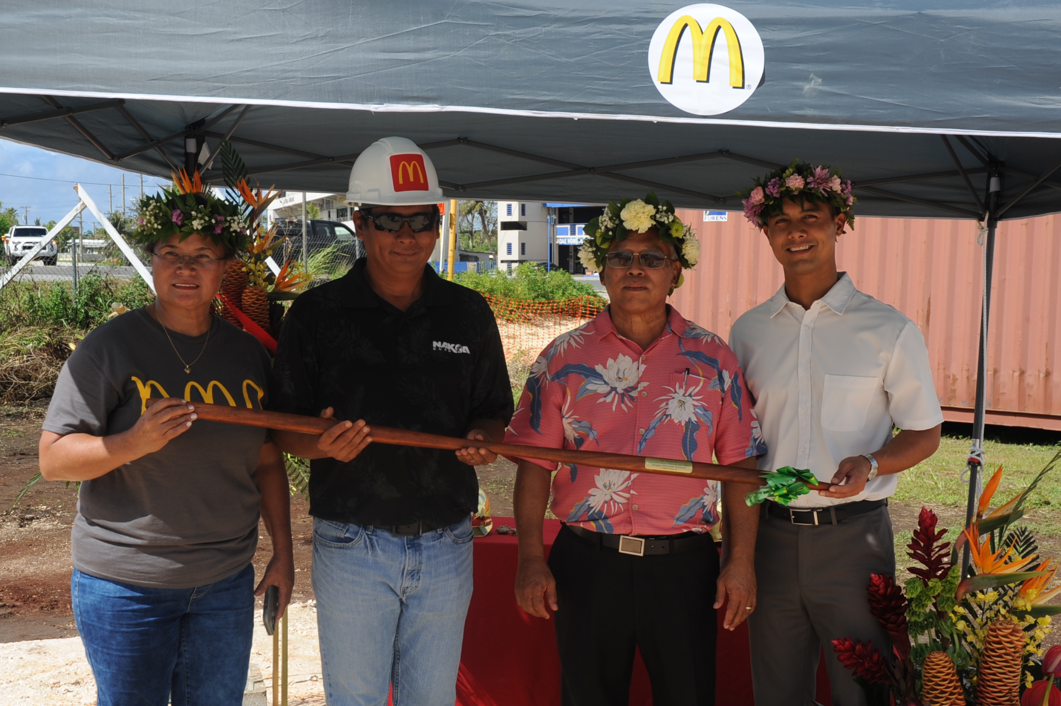 The Ayuyus accept a traditional Hawaiian digging tool called the “O’o” from Noel Lomtong, project manager, Nakoa Guam Inc. From left, Marsha Ayuyu, Lomtong, Joe Ayuyu Sr. and Joe Ayuyu Jr. Photo by Justin Green