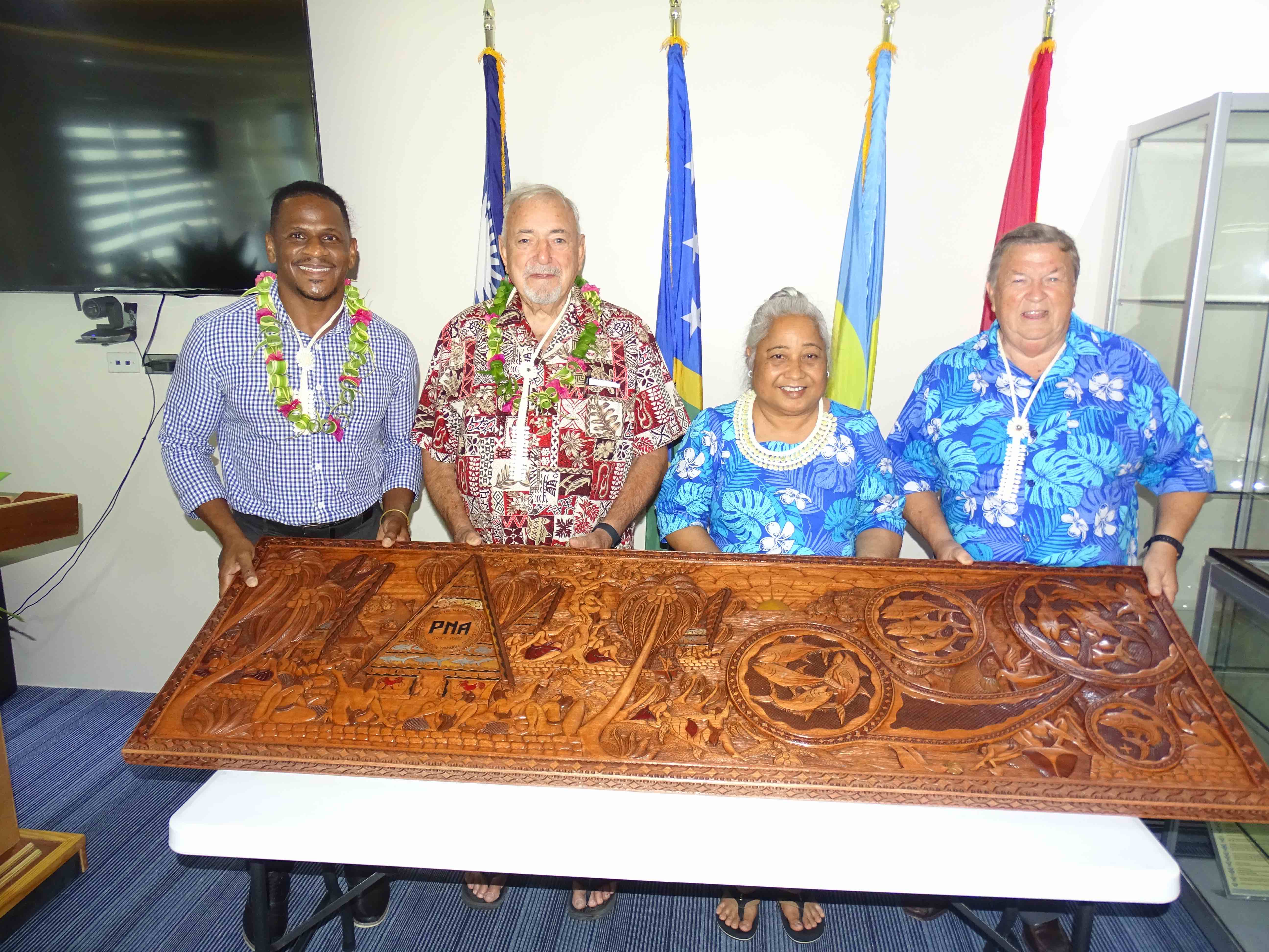 (from left) U.S. Embassy Chargé d’affaires Jeremiah Knight; Joseph “Jerry” Kramer Pacific CEO of Pacific International Inc.; PNA Office CEO Sangaa Clark, CEO of the PNA Office; and Les Clark, husband to Sangaa. The group are shown with a specially made Palauan storyboard, depicting the PNA story. 
